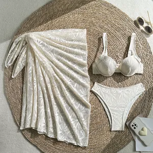 Detailed view of cream lace 3-piece bikini set with matching beach cover-up