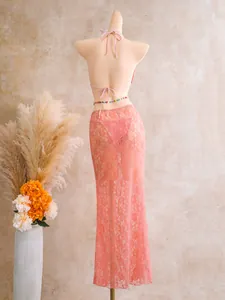 Back view of pink lace three-piece bikini set with long mesh skirt on mannequin