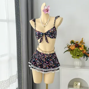 Elegant floral print two-piece bikini set featuring ruffle straps and lace hem skirt detail