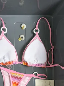 Detail view of pink gradient chevron bikini with white rings and inner lining