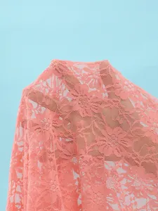 Macro detail showing texture of delicate pink floral lace mesh fabric for swimwear