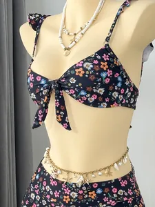 Macro view of floral bikini with ruffle straps and front knot on mannequin for beach