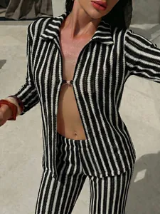 Close-up of black and white striped mesh resort wear set for beach vacation