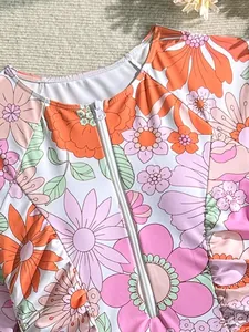 Vibrant colorful floral long-sleeve one-piece swimsuit featuring front white zipper closure