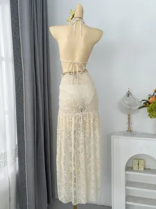 Gedetailleerd achteraanzicht van een elegante driedelige crème kant bikini set met rok.