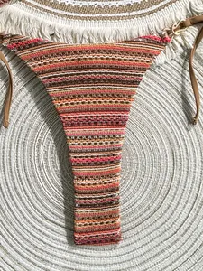 Close-up detail of striped crochet bikini bottom with vibrant color-blocking texture