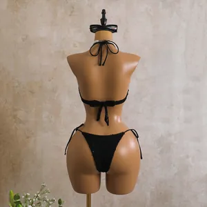 Back view of black sequined bikini set on mannequin with textured fabric detail