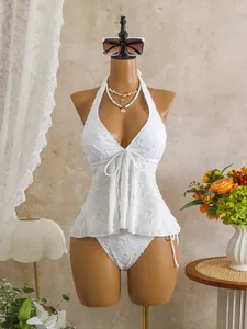 Detailed macro view of white textured tankini set with floral pattern on mannequin