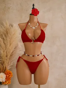 Red textured triangle bikini set on mannequin with seashell necklace accessories