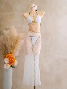 Detailed look at white lace 3-piece bikini set with long mesh skirt on mannequin
