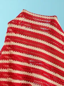 Detailed macro shot of red and cream striped crochet mesh fabric for beachwear