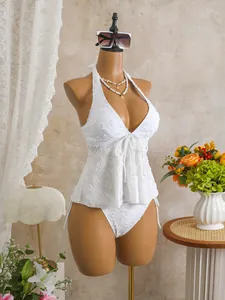 Macro view of white textured fabric and drawstring details on a halter neck tankini swimsuit
