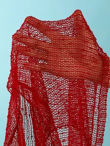 Detailed macro close-up of red sequined mesh fabric showing texture and transparency