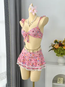 Floral two-piece bikini set with ruffles and lace detail displayed on a mannequin.
