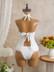 Detailed back view of a white textured floral tankini set with elegant bow tie closures