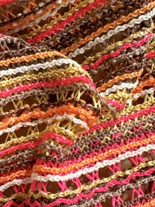 Macro view of vibrant striped crochet knitted fabric detail for beach holiday bikini