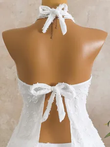 Detail of white floral textured halter tankini with back tie knots on mannequin