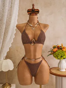 Detailed view of a brown crochet bikini set with starfish waist chain on a mannequin