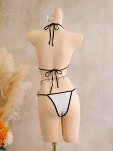 Back view of a white lace three-piece bikini set with an elegant pearl waist chain accessory