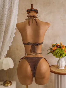 Back view detail of brown crochet bikini with starfish belly chain on mannequin