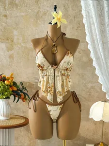 Exquisite two-piece sequin floral bikini set displayed on a vintage style mannequin.
