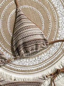 Detailed close-up view of a striped bohemian crochet bikini top with refined knit texture