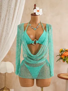 Detail view of a three-piece sequin mesh bikini set with long sleeve cover-up in turquoise