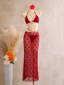 Detailed view of sexy red lace three-piece bikini set featuring a sheer floral cover-up skirt