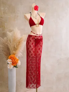 Detailed view of women's red three-piece lace bikini set with matching long mesh skirt