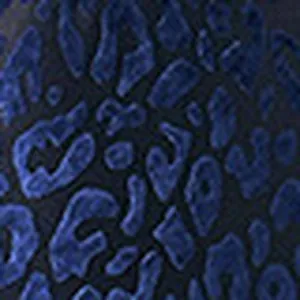 Macro detail showing the dark blue leopard print texture of the high-stretch swimwear fabric.