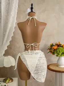 Back view of elegant white lace three-piece bikini set with beach cover-up skirt