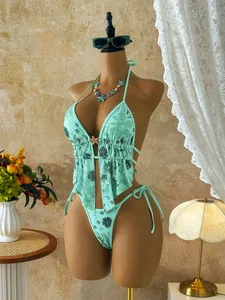 Detail view of mint green bikini set featuring floral sequins and starfish ornament