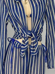 Close-up view of a blue and white striped crochet beach set featuring a tie-front detail