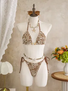 Detail of brown crochet bikini with white swirl embroidery and starfish accessories
