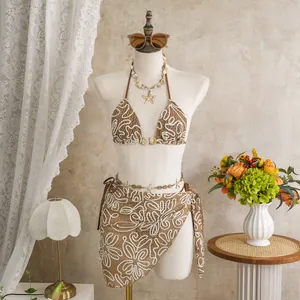 Full view of three-piece brown crochet bikini set with embroidered sarong on mannequin