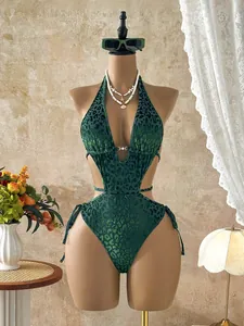 Detail view of green leopard print cutout swimsuit with halter neck and tie-up sides
