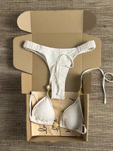 Textured off-white triangle bikini set with gold bead details in premium box packaging