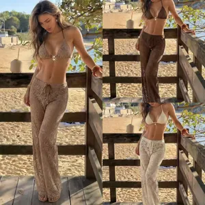 Three-piece bikini set with leaf pattern pants in beige, brown, and white colors.