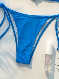 Close-up van een levendig blauw bikinibroekje met verstelbare strikjes aan de zijkant