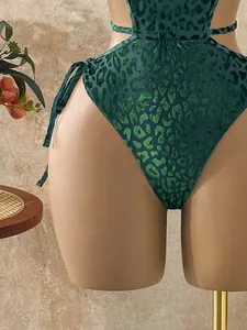 Detail of green velvet leopard print one-piece swimsuit with cutout and side ties