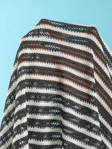 Macro detail showing the striped mesh knit texture of a semi-transparent beach cover-up