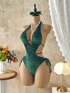 Detail view of green leopard print cutout one-piece swimsuit on mannequin.