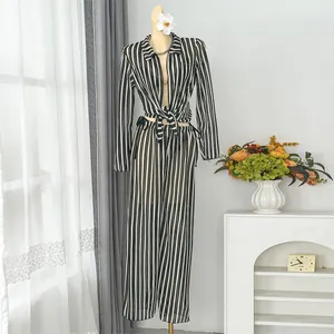 Mannequin wearing a black and white striped tie-front top and wide-leg beach pants set.