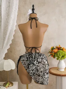 Detailed back view of a sexy black bikini set with a white lace beach wrap skirt