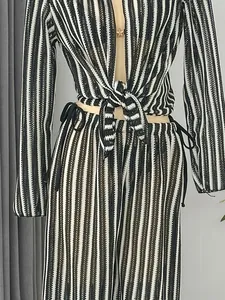 Detailed view of striped crochet beachwear set featuring tie-front top and pants