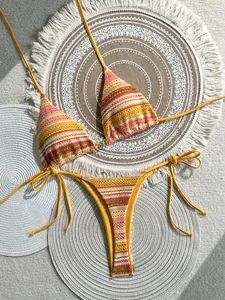 Macro detail of colorful striped crochet bikini with boho patterns