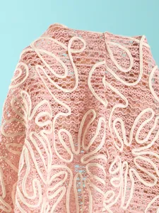 Detailed close-up showing the intricate pink crochet and white embroidery of this bikini set
