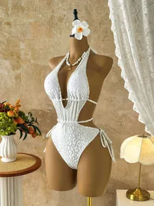 Elegant white leopard print monokini swimsuit displayed on a female mannequin torso