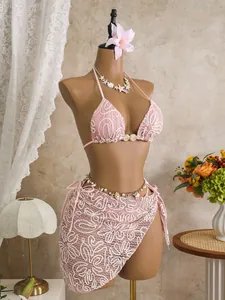 Detailed view of pink lace bikini set with matching beach sarong cover-up