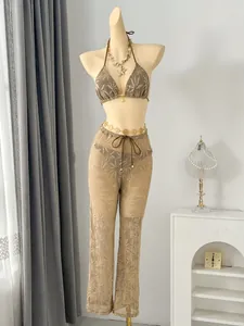 Detail view of a three-piece leaf pattern bikini set with wide-leg mesh trousers